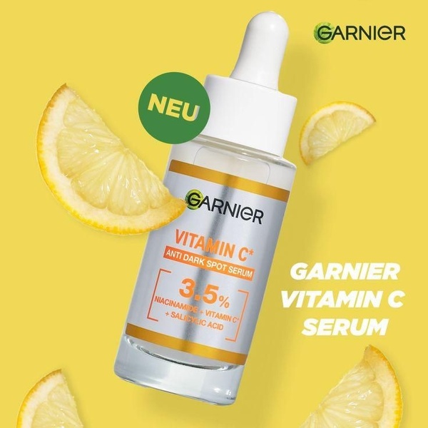 A clean, high-contrast product-focused creative featuring a serum bottle isolated against a bright yellow background with citrus accents.